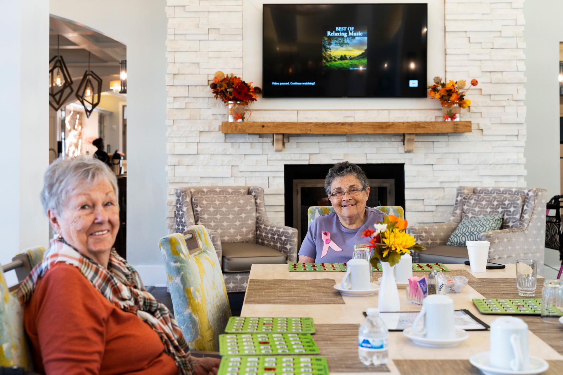 Assisted living residents playing bingo Two senior residents play bingo at a large table