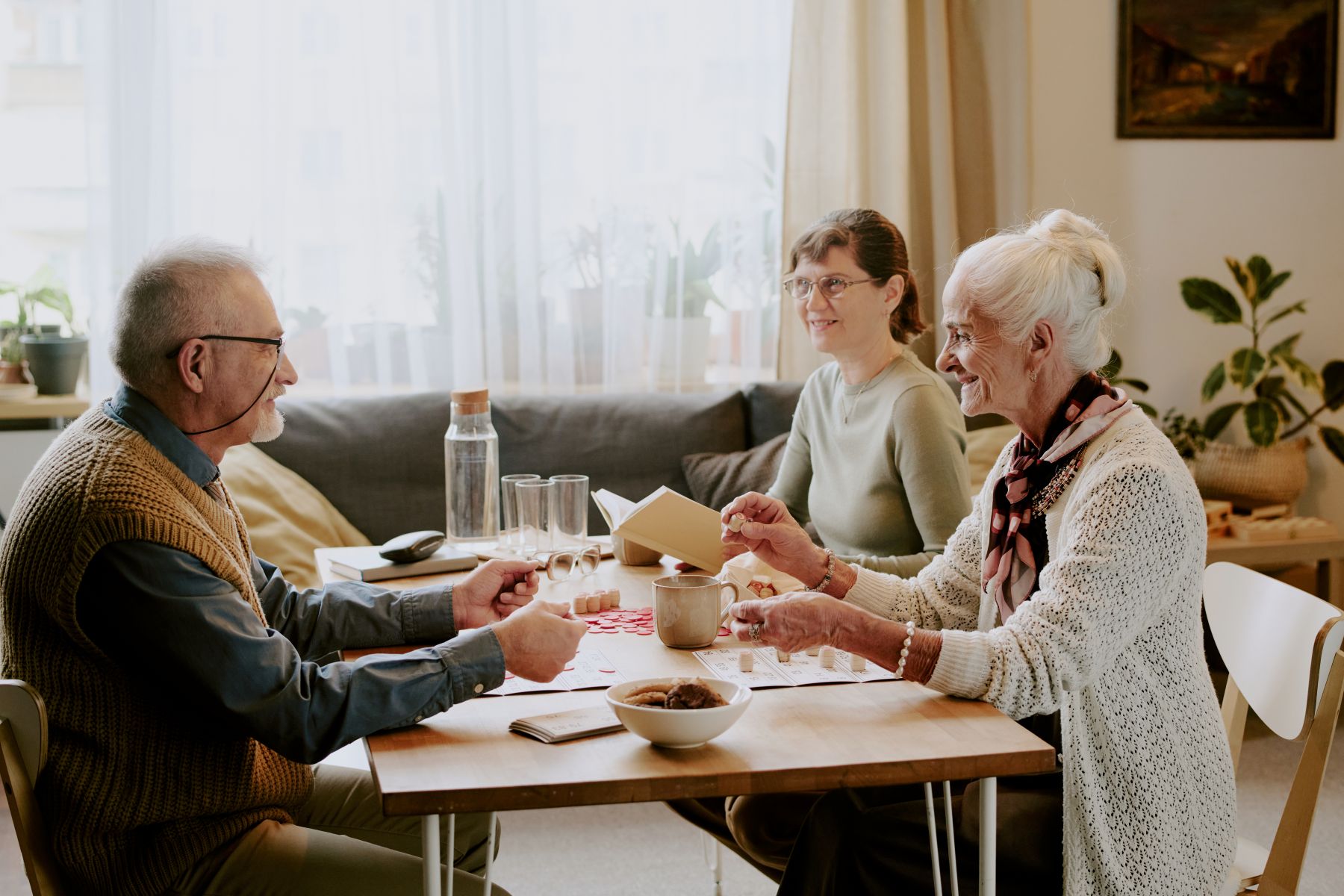 senior man and women playing cards together