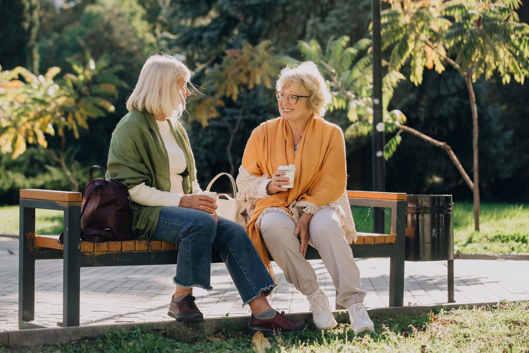 senior woman talking outside on bench